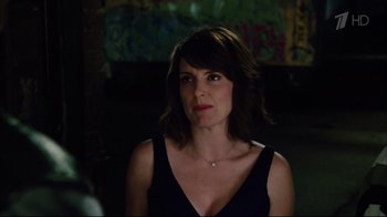 Movie still from “Date Night” (2010), directed by Shawn Levy – A woman in a black dress is looking at the camera; Close Up shot, Over the shoulder angle