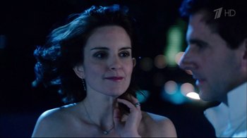 Movie still from “Date Night” (2010), directed by Shawn Levy – A beautiful woman with dark hair wearing a diamond necklace; Close Up shot, Over the shoulder angle
