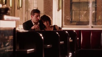 Movie still from “Date Night” (2010), directed by Shawn Levy – A man and a woman sitting on a bench in front of a window; Medium shot, Over the shoulder angle