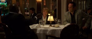 Movie still from “The Internship” (2013), directed by Shawn Levy – A man taking a picture of a woman at a dinner table; Medium shot, Over the shoulder angle