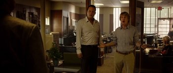 Movie still from “The Internship” (2013), directed by Shawn Levy – Two men standing in an office with one holding a remote control; Medium shot, Over the shoulder angle