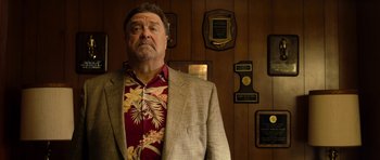 Movie still from “The Internship” (2013), directed by Shawn Levy – A man standing in front of a wooden wall; Medium shot, Low angle