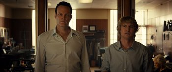 Movie still from “The Internship” (2013), directed by Shawn Levy – A man standing next to another man in a room; Medium shot, Low angle