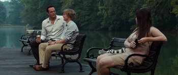 Movie still from “The Internship” (2013), directed by Shawn Levy – Two men sitting on park benches next to a body of water; Wide shot, Over the shoulder angle