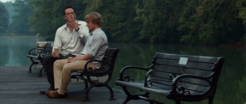 Movie still from “The Internship” (2013), directed by Shawn Levy – Two men sitting on park benches near a body of water; Medium shot, Over the shoulder angle