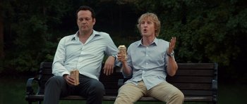 Movie still from “The Internship” (2013), directed by Shawn Levy – Two men sitting on a park bench eating sandwiches; Medium shot, Over the shoulder angle