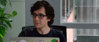 Movie still from “The Internship” (2013), directed by Shawn Levy – A man with glasses is sitting in front of a computer; Close Up shot, Over the shoulder angle