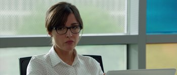 Movie still from “The Internship” (2013), directed by Shawn Levy – A woman in a white polka dot shirt is looking at a computer screen; Close Up shot, Over the shoulder angle