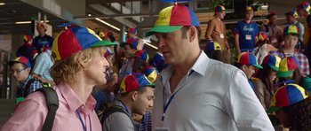 Movie still from “The Internship” (2013), directed by Shawn Levy – A group of people wearing colorful hats in a room; Medium shot, Over the shoulder angle