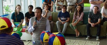 Movie still from “The Internship” (2013), directed by Shawn Levy – A group of people watching a man play a video game; Medium shot, Over the shoulder angle