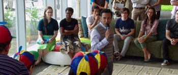 Movie still from “The Internship” (2013), directed by Shawn Levy – A group of people sitting in a living room; Medium shot, Over the shoulder angle