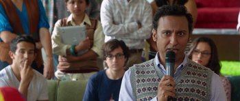 Movie still from “The Internship” (2013), directed by Shawn Levy – A man holding a microphone in front of a group of people; Medium shot, Over the shoulder angle