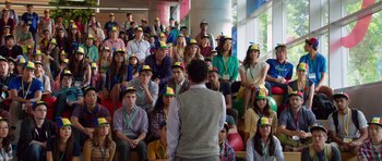 Movie still from “The Internship” (2013), directed by Shawn Levy – A group of people sitting in front of a man wearing a hat; Medium shot, Over the shoulder angle