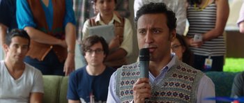 Movie still from “The Internship” (2013), directed by Shawn Levy – A man holding a microphone in front of a group of people; Medium shot, Over the shoulder angle
