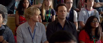Movie still from “The Internship” (2013), directed by Shawn Levy – A man and a woman sitting next to each other in front of a crowd; Close Up shot, Over the shoulder angle