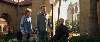 Movie still from “The Internship” (2013), directed by Shawn Levy – A man sitting on a bench next to two other people; Wide shot, Over the shoulder angle