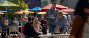 Movie still from “The Internship” (2013), directed by Shawn Levy – A group of people sitting at a table with food on it; Medium shot, Over the shoulder angle