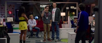 Movie still from “The Internship” (2013), directed by Shawn Levy – Two men standing next to each other in front of a red couch; Wide shot, Over the shoulder angle