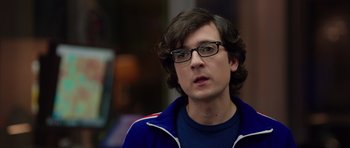 Movie still from “The Internship” (2013), directed by Shawn Levy – A man with glasses and a blue jacket looking to his left; Close Up shot, Over the shoulder angle