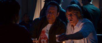 Movie still from “The Internship” (2013), directed by Shawn Levy – Two men sitting at a table with drinks in front of them; Medium shot, Over the shoulder angle