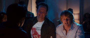 Movie still from “The Internship” (2013), directed by Shawn Levy – A man sitting next to another man in a room; Medium shot, Over the shoulder angle