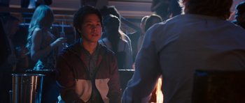 Movie still from “The Internship” (2013), directed by Shawn Levy – A man sitting in front of a fire in front of a group of people; Medium shot, Over the shoulder angle