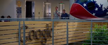 Movie still from “The Internship” (2013), directed by Shawn Levy – Two people standing in front of a google sign; Wide shot, Low angle