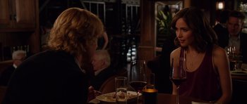 Movie still from “The Internship” (2013), directed by Shawn Levy – A woman sitting at a table with a plate of food; Medium shot, Over the shoulder angle