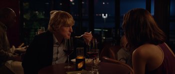 Movie still from “The Internship” (2013), directed by Shawn Levy – A man sitting at a table with a fork in his mouth; Medium shot, Over the shoulder angle
