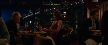 Movie still from “The Internship” (2013), directed by Shawn Levy – A woman sitting at a table with a glass of red wine; Medium shot, Over the shoulder angle