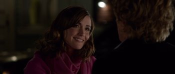 Movie still from “The Internship” (2013), directed by Shawn Levy – A woman in a pink scarf smiling at the camera; Close Up shot, Over the shoulder angle