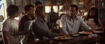 Movie still from “The Internship” (2013), directed by Shawn Levy – Two men sitting at a table in front of a plate of pizza; Medium shot, Over the shoulder angle