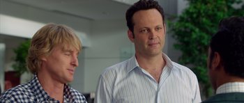 Movie still from “The Internship” (2013), directed by Shawn Levy – A man in a blue and white striped dress shirt and a woman in a checkered shirt; Close Up shot, Over the shoulder angle