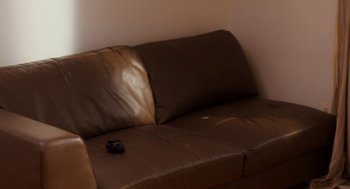 Movie still from “Dating & New York” (2021), directed by Jonah Feingold – A couch with a remote control on the back of it; Extreme Close Up shot, High angle