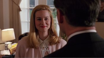 Movie still from “Dave” (1993), directed by Ivan Reitman – A woman with blonde hair wearing a pink shirt; Close Up shot, Over the shoulder angle