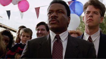 Movie still from “Dave” (1993), directed by Ivan Reitman – A man in a suit and a tie; Close Up shot, Low angle
