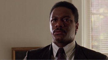 Movie still from “Dave” (1993), directed by Ivan Reitman – A person wearing a suit and tie; Close Up shot, Low angle