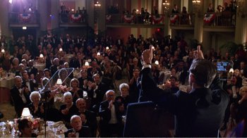 Movie still from “Dave” (1993), directed by Ivan Reitman – A crowd of people sitting in a room; Wide shot, High angle