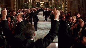 Movie still from “Dave” (1993), directed by Ivan Reitman – A crowd of people in suits and ties in a hallway; Wide shot, High angle
