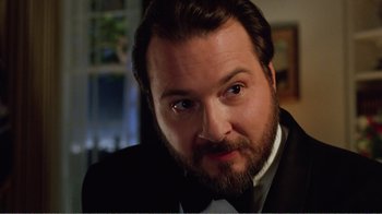 Movie still from “Dave” (1993), directed by Ivan Reitman – A person wearing a suit and tie; Close Up shot, Low angle