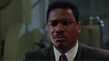 Movie still from “Dave” (1993), directed by Ivan Reitman – A person wearing a suit and tie; Close Up shot, Low angle