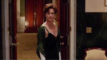 Movie still from “Dave” (1993), directed by Ivan Reitman – A woman in a green dress standing in front of a door; Medium shot, Over the shoulder angle