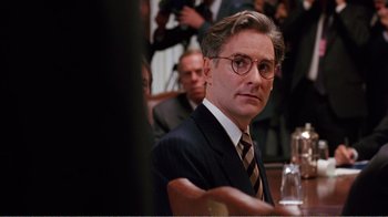 Movie still from “Dave” (1993), directed by Ivan Reitman – A person wearing a suit and tie; Close Up shot, Over the shoulder angle