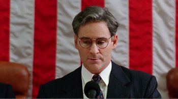 Movie still from “Dave” (1993), directed by Ivan Reitman – A person wearing a suit and tie; Close Up shot, Low angle