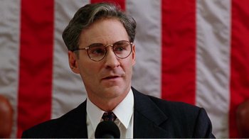 Movie still from “Dave” (1993), directed by Ivan Reitman – A person wearing a suit and tie; Close Up shot, Low angle