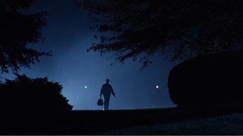 Movie still from “Dave” (1993), directed by Ivan Reitman – A person walking on a hill at night; Extreme Wide shot, Low angle