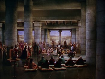 Movie still from “David and Bathsheba” (1951), directed by Henry King – A group of people sitting on the floor of a building; Extreme Wide shot, High angle