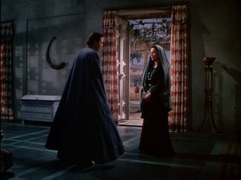 Movie still from “David and Bathsheba” (1951), directed by Henry King – A man and a woman standing next to each other in front of an open door; Wide shot, Over the shoulder angle