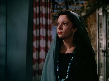 Movie still from “David and Bathsheba” (1951), directed by Henry King – A woman wearing a black dress and a green head covering; Medium shot, Low angle
