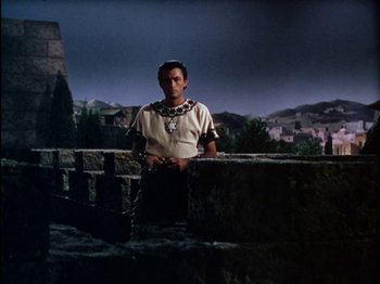 Movie still from “David and Bathsheba” (1951), directed by Henry King – A man standing on top of a stone wall; Medium shot, Low angle